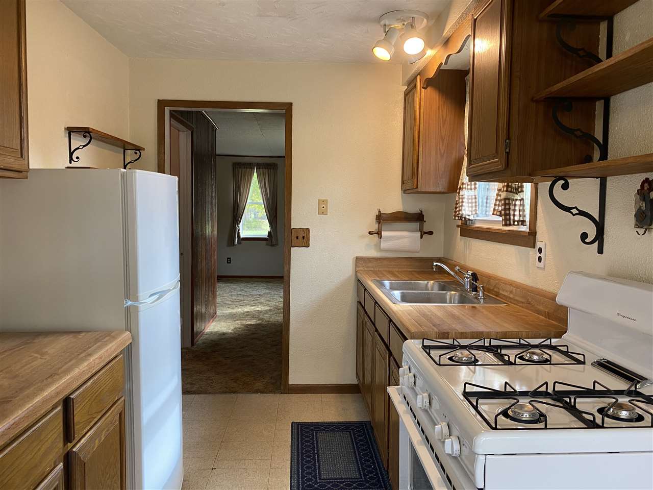 10979 2nd Street Roscoe, IL 61073 - Photo 13 of 30 a kitchen with a stove and a refrigerator
