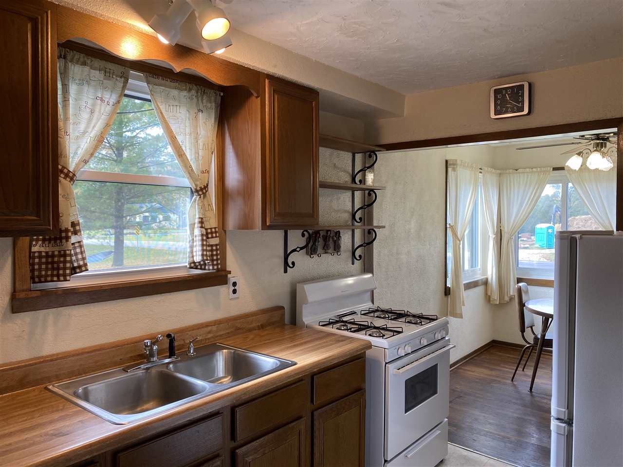 10979 2nd Street Roscoe, IL 61073 - Photo 16 of 30 a kitchen that has a sink a stove and a refrigerator