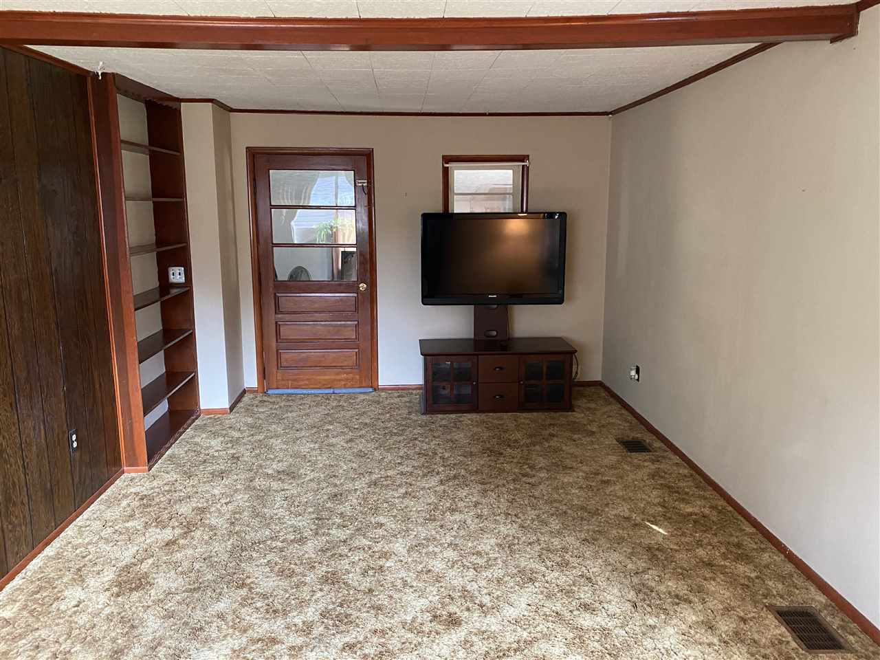 10979 2nd Street Roscoe, IL 61073 - Photo 20 of 30 a living room with furniture and a flat screen tv