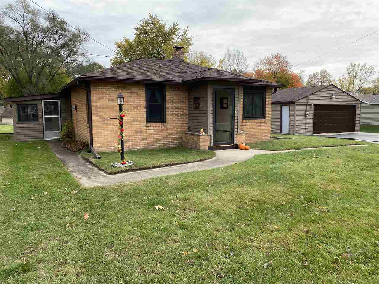 10979 2nd Street Roscoe, IL 61073 - Photo 2 of 30 a front view of a house with a garden