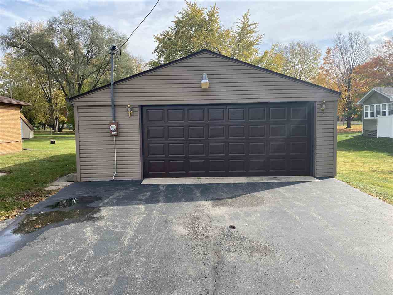 10979 2nd Street Roscoe, IL 61073 - Photo 30 of 30 a front view of a house with a yard and garage
