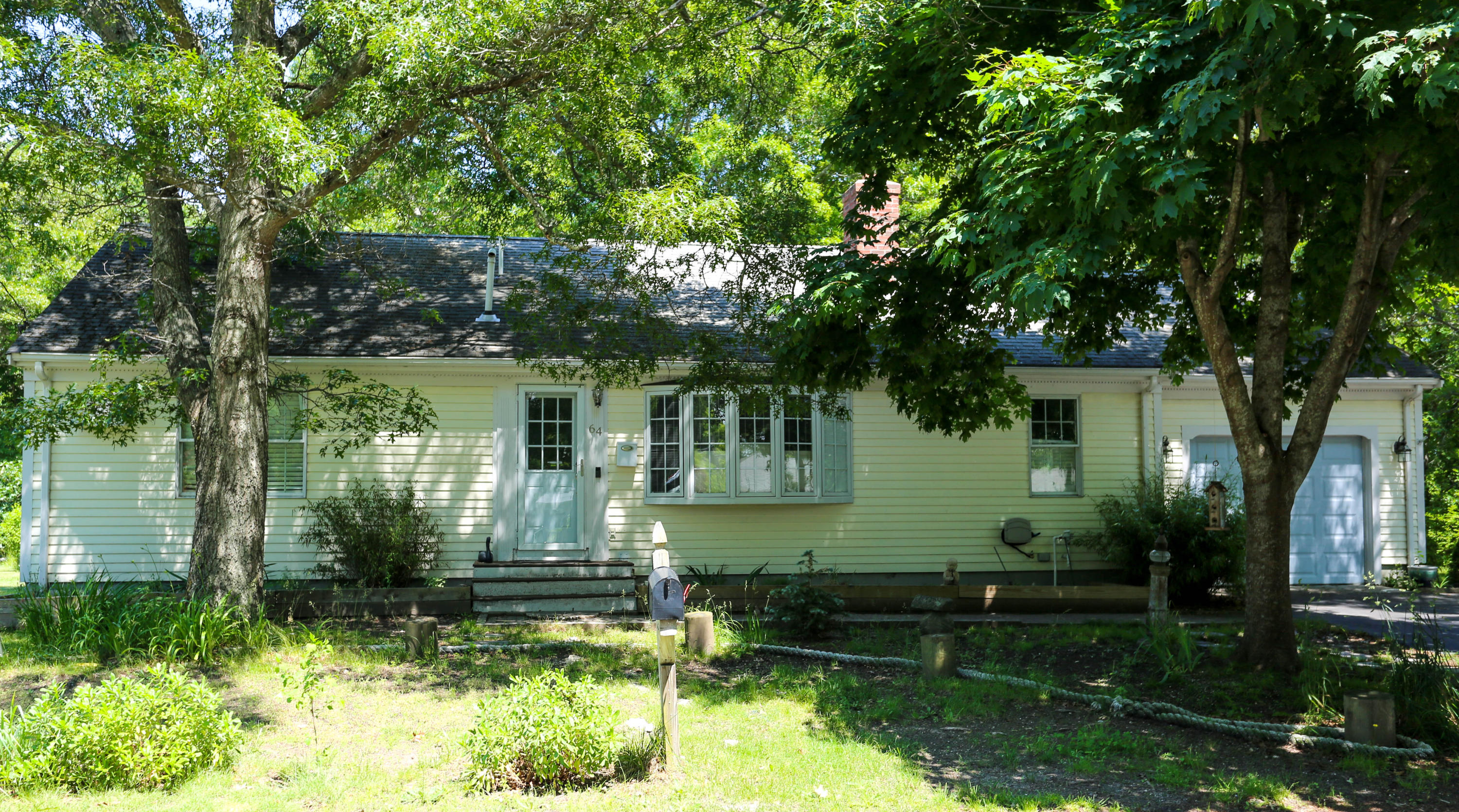 64 Crooked Pond Road Hyannis, MA 02601 - Photo 1 of 21 a front view of a house with garden