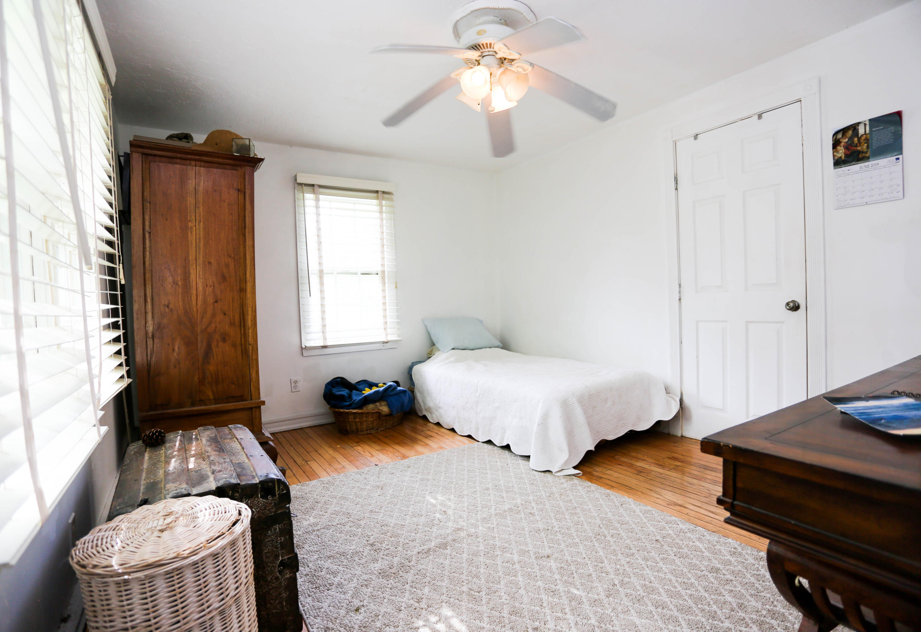 64 Crooked Pond Road Hyannis, MA 02601 - Photo 13 of 21 a bedroom with a bed and a chandelier