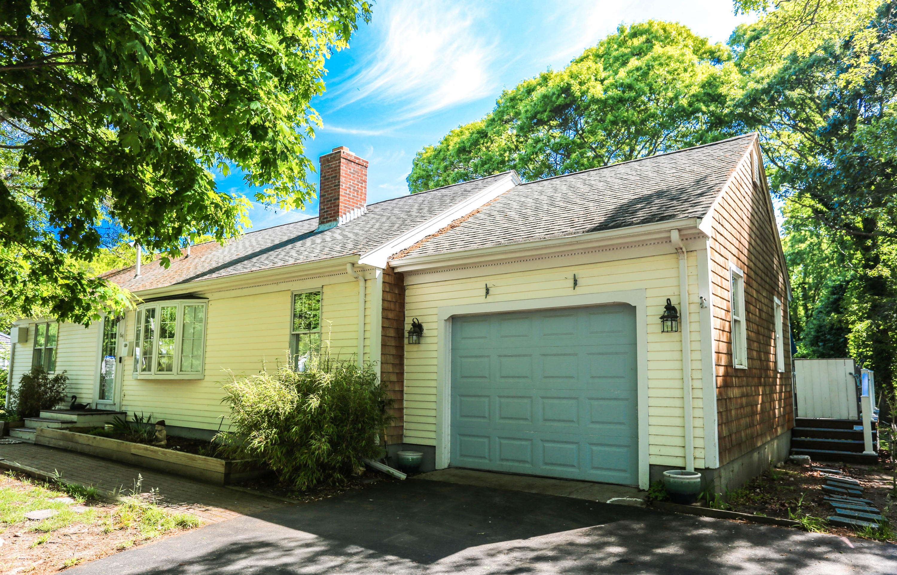 64 Crooked Pond Road Hyannis, MA 02601 - Photo 2 of 21 a front view of a house with a garden