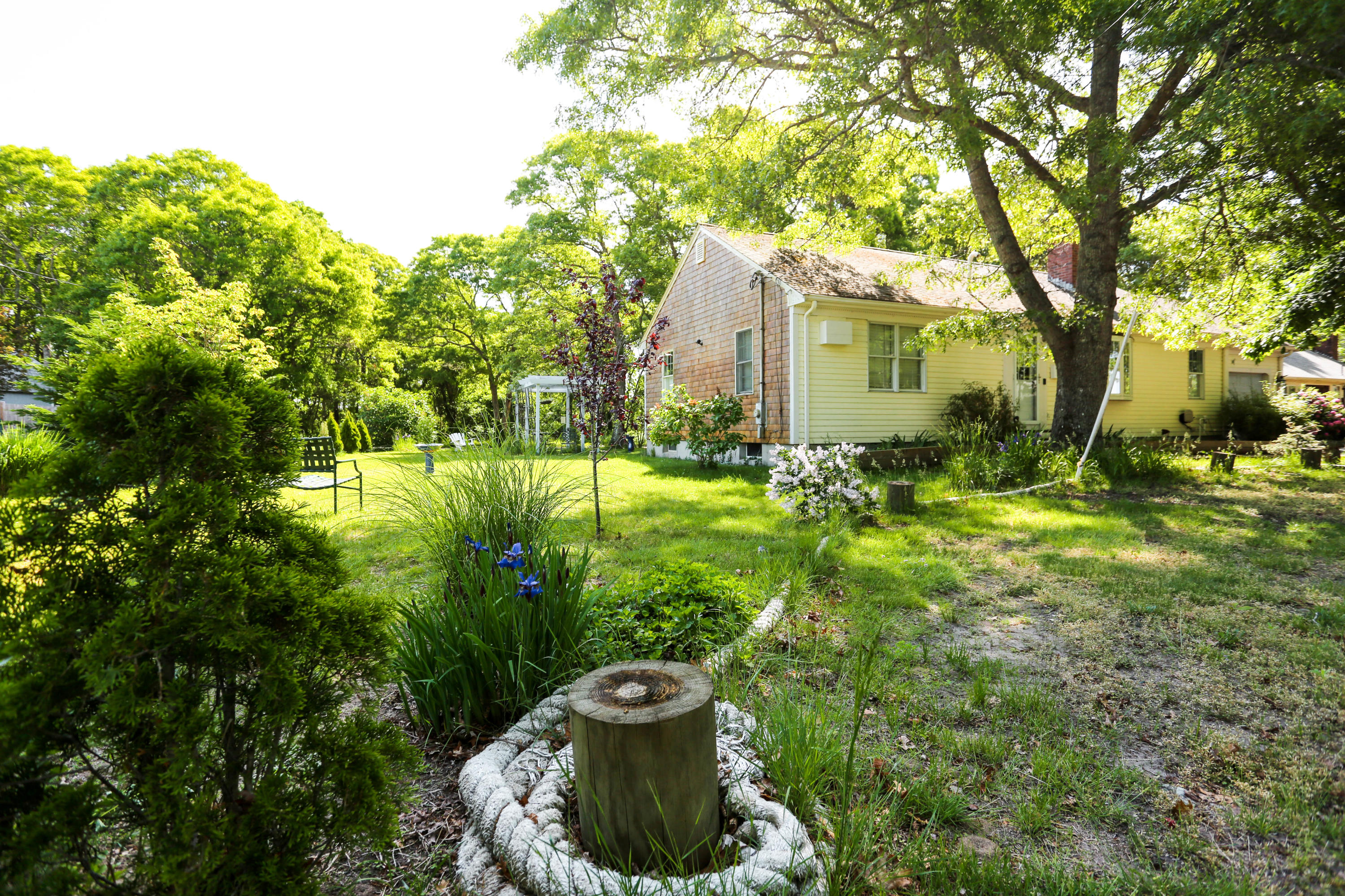 64 Crooked Pond Road Hyannis, MA 02601 - Photo 3 of 21 a view of a garden with a fountain