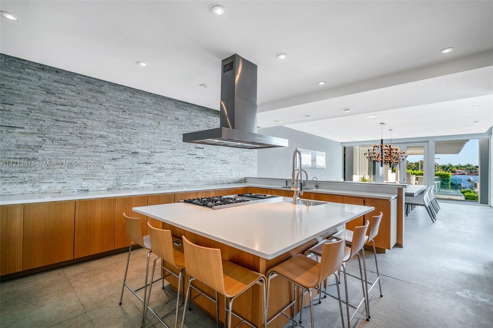 1236 Biscaya Drive Surfside, FL 33154 - Photo 12 of 40 a kitchen with a table and chairs in it