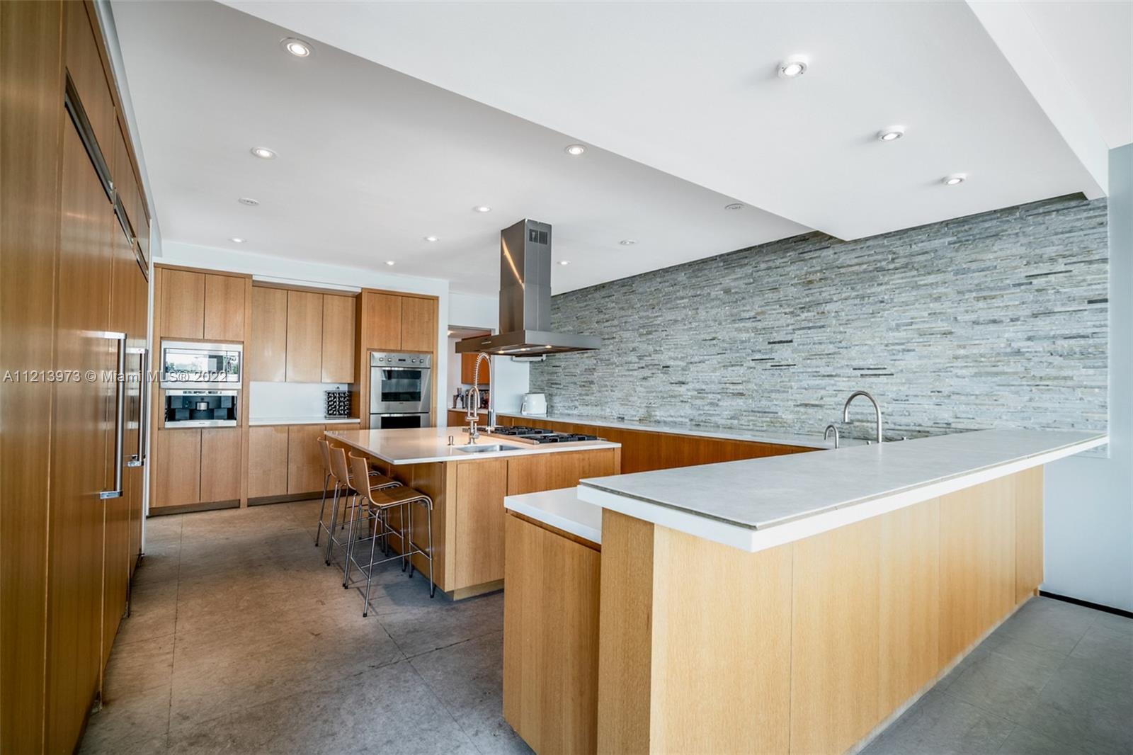 1236 Biscaya Drive Surfside, FL 33154 - Photo 13 of 40 a kitchen with stainless steel appliances a sink and a refrigerator