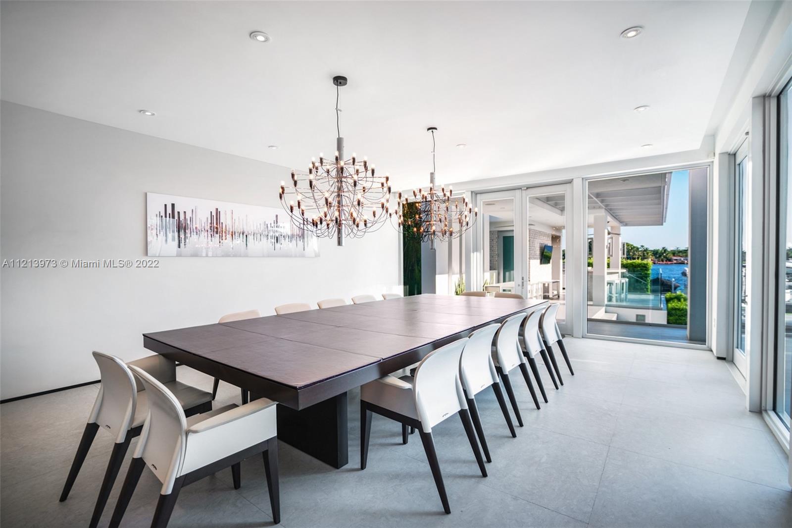 1236 Biscaya Drive Surfside, FL 33154 - Photo 14 of 40 a view of a dining room and livingroom with furniture wooden floor a chandelier