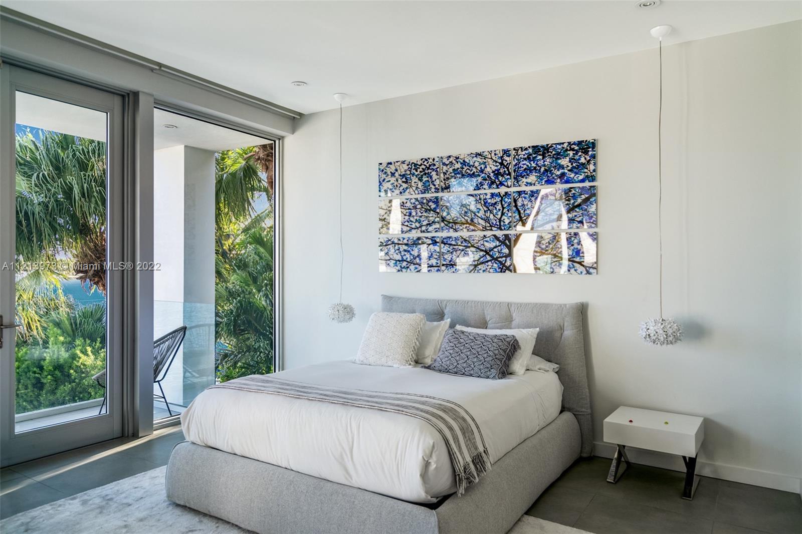 1236 Biscaya Drive Surfside, FL 33154 - Photo 22 of 40 a bedroom with a bed and a window