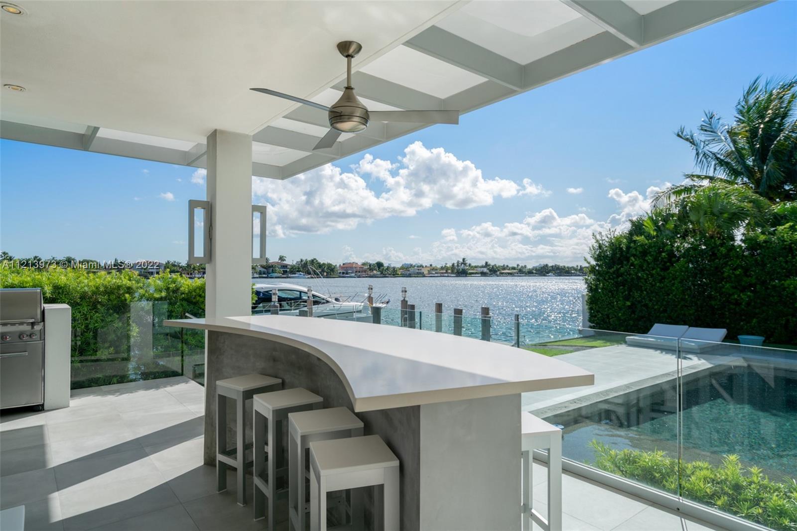 1236 Biscaya Drive Surfside, FL 33154 - Photo 24 of 40 a view of a balcony with table and chairs