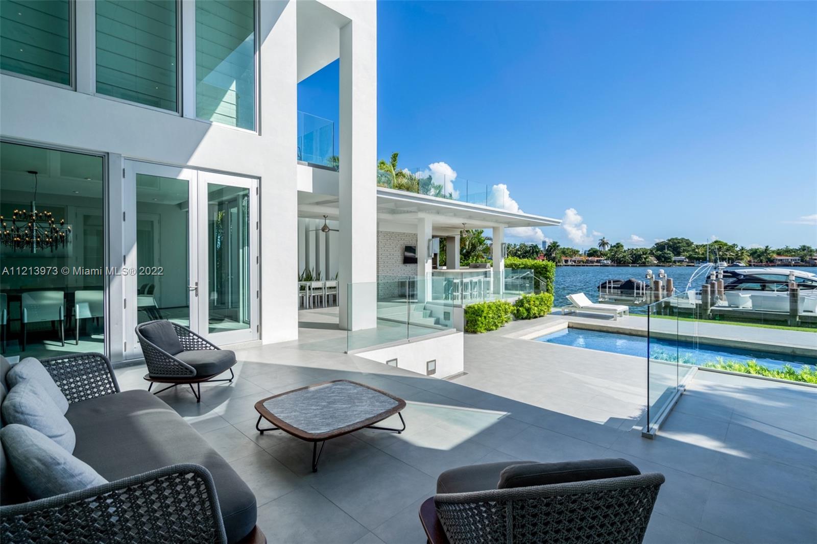 1236 Biscaya Drive Surfside, FL 33154 - Photo 25 of 40 a building outdoor space with patio furniture and glass door