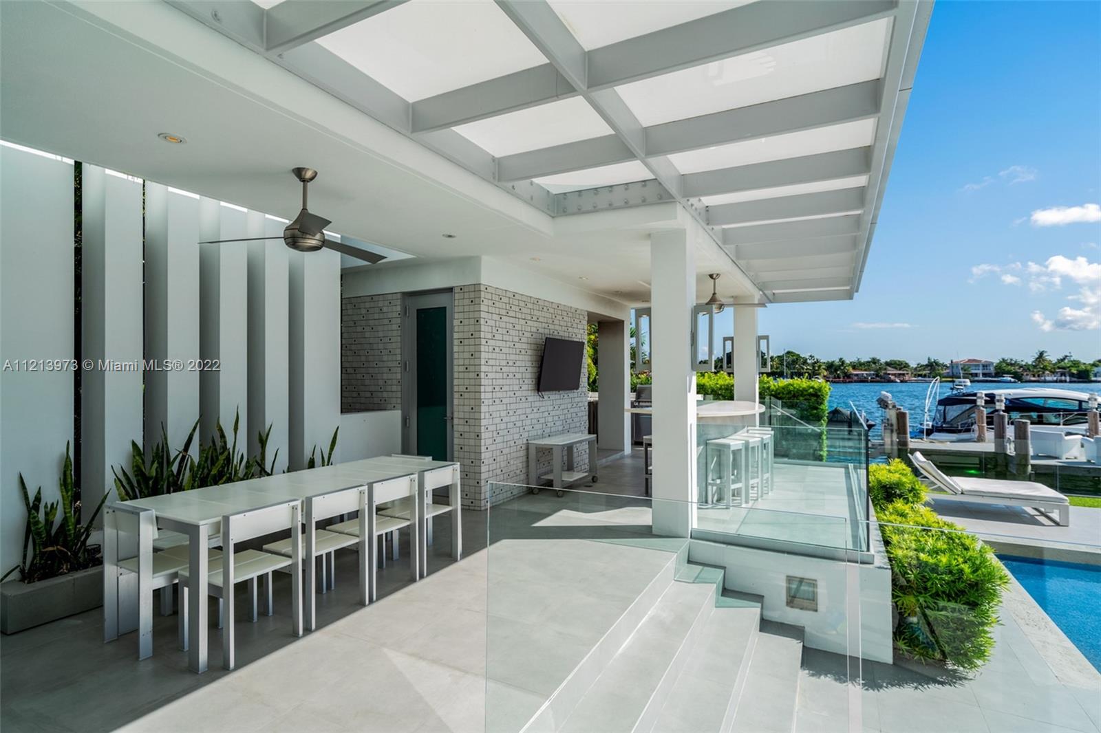 1236 Biscaya Drive Surfside, FL 33154 - Photo 26 of 40 a patio with a table and chairs