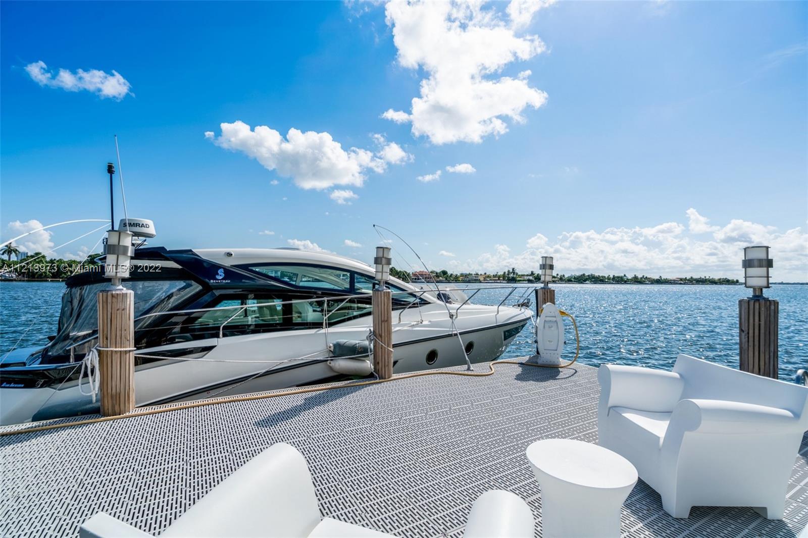 1236 Biscaya Drive Surfside, FL 33154 - Photo 36 of 40 a living room with furniture a rug and a fireplace