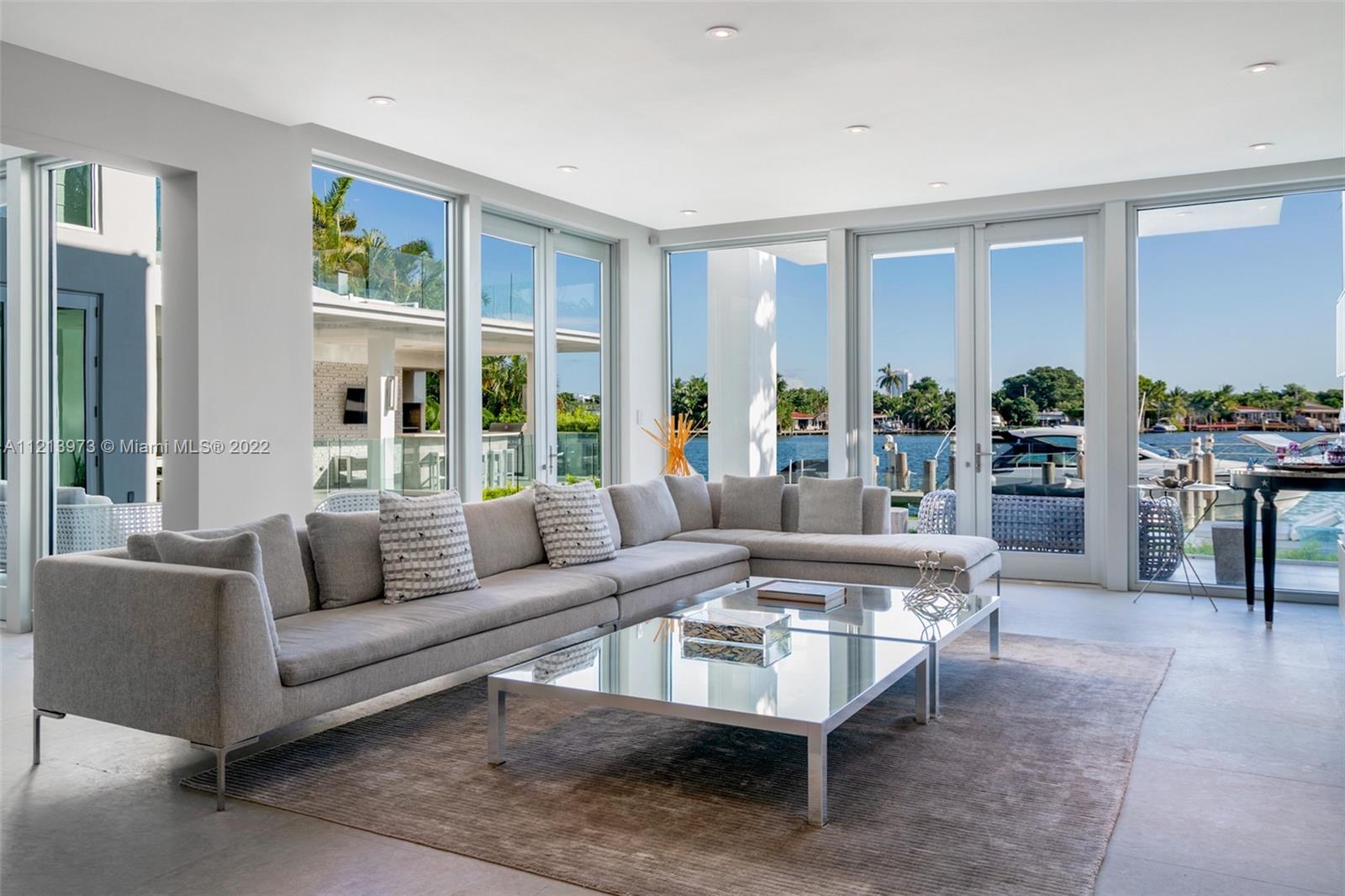 1236 Biscaya Drive Surfside, FL 33154 - Photo 10 of 40 a living room with furniture and large windows