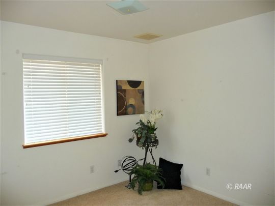 1129 Porter Street Ridgecrest, CA 93555 - Photo 16 of 22 a potted plant sitting on top of a wooden floor