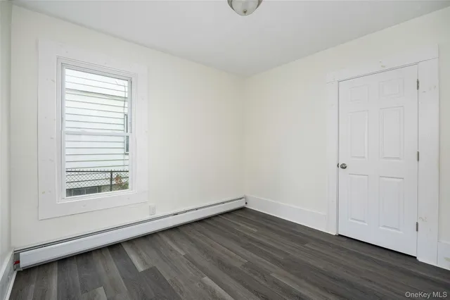 a view of a small space with wooden floor and a window