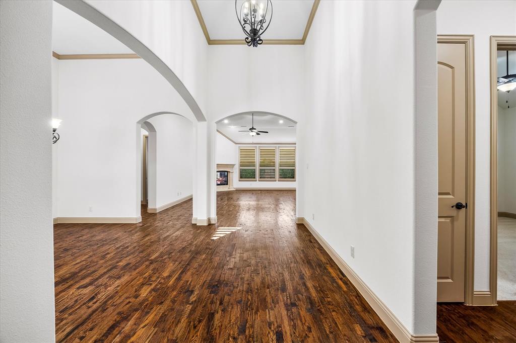 6814 Springwood Lane Garland, TX 75044 - Photo 8 of 35 a view of a hallway with wooden floor and staircase