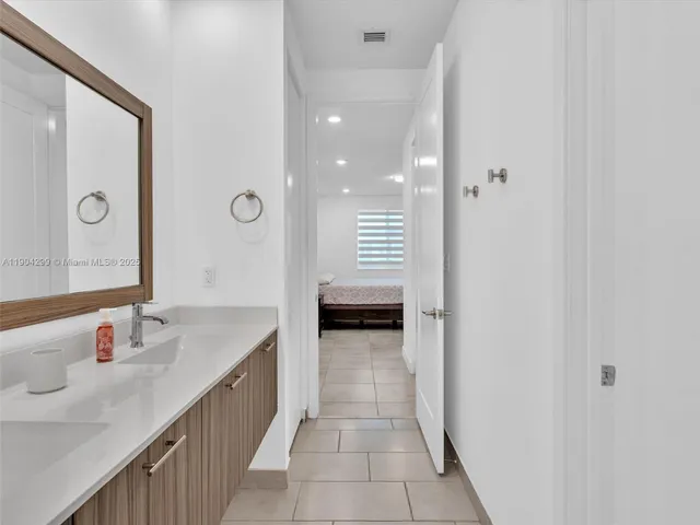 a large bed sitting in a bedroom next to a window