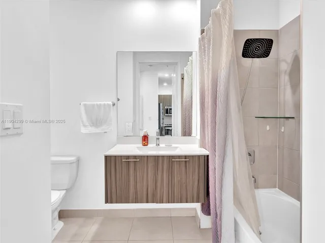 a bedroom with two beds and painting on the wall