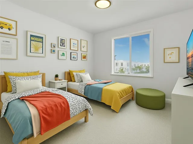 a living room with couches and kitchen view with a large window