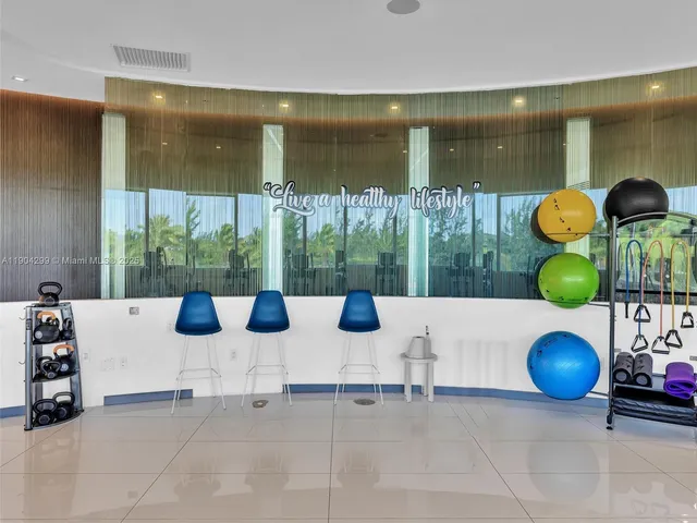 a kitchen with a large pool table and chairs