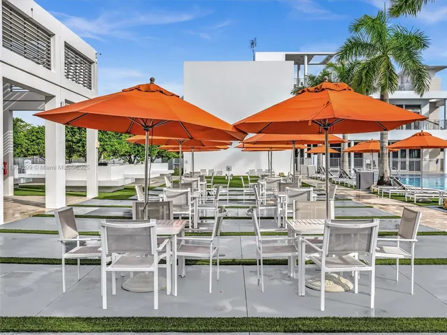 a living room with furniture a flat screen tv and a large window