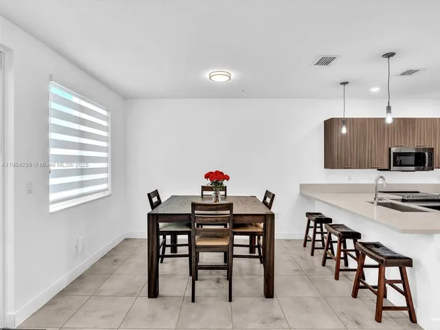 a view of a dining room with furniture and a window