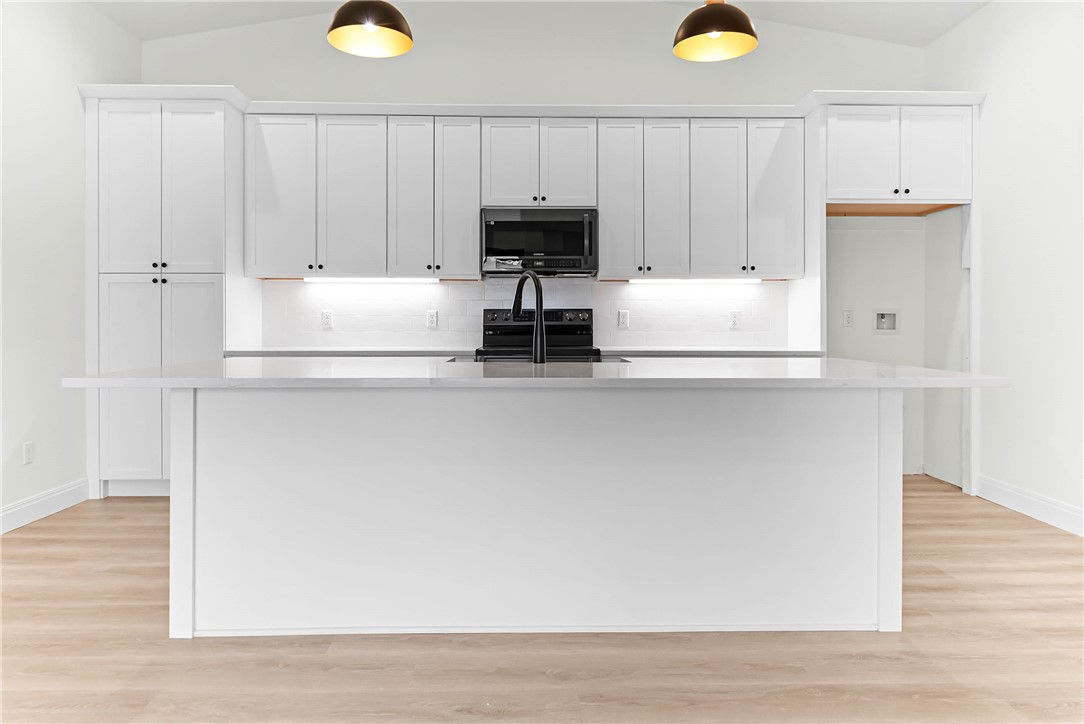 1210 West Dallas Seadrift, TX 77983 - Photo 17 of 21 a kitchen with a white cabinets and a stove