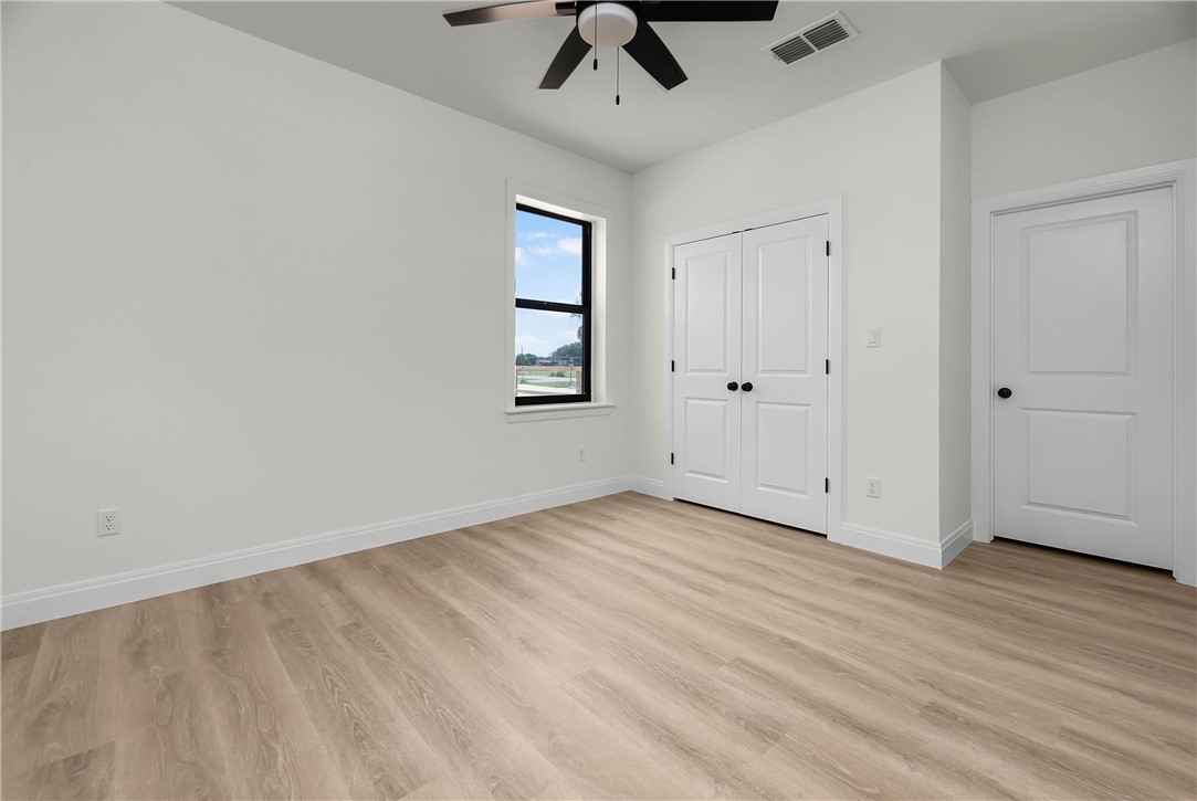 1210 West Dallas Seadrift, TX 77983 - Photo 19 of 21 wooden floor in an empty room with a window