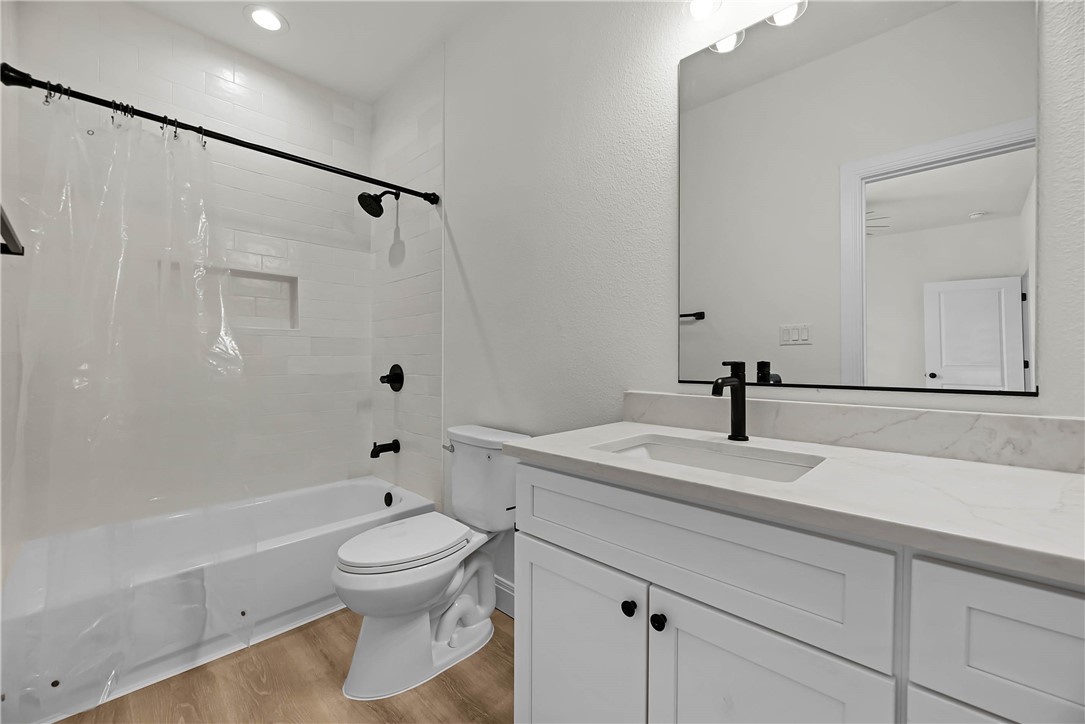 1210 West Dallas Seadrift, TX 77983 - Photo 20 of 21 a bathroom with a granite countertop toilet a sink and a bathtub