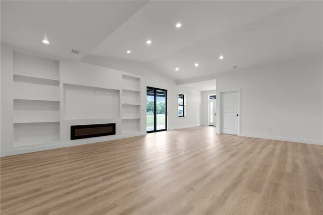 a view of a room with an empty space and a window