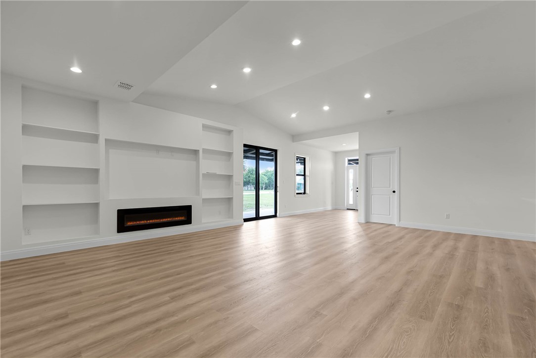 1210 West Dallas Seadrift, TX 77983 - Photo 4 of 21 a view of an empty room with a window and wooden floor