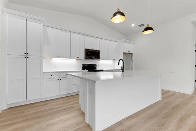 a kitchen with cabinets and window