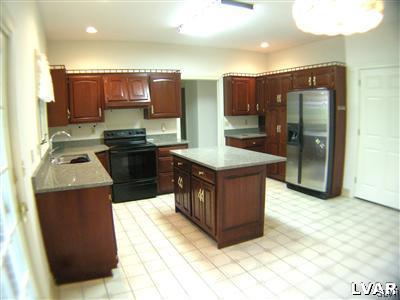 532 Roberts Road Nazareth, PA 18064 - Photo 19 of 34 a kitchen with stainless steel appliances granite countertop a stove a refrigerator and a sink