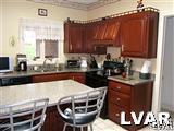 532 Roberts Road Nazareth, PA 18064 - Photo 21 of 34 a kitchen with granite countertop a stove a sink and a microwave