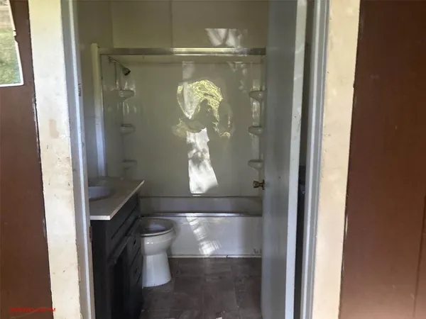 a room with water heater and wooden door