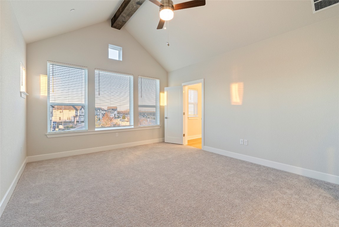 1057 Brickell Loop Austin, TX 78744 - Photo 15 of 33 an empty room with windows and chandelier fan