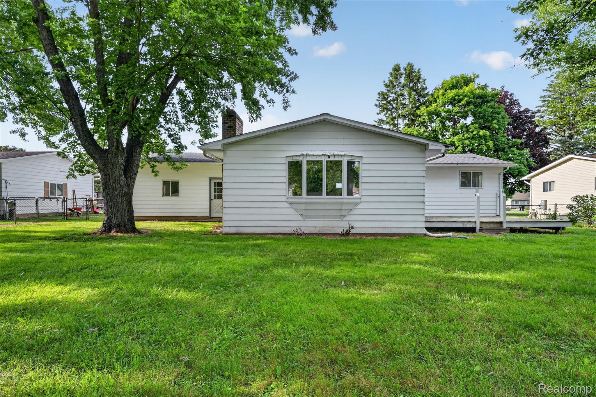 5457 Reid Road Swartz Creek, MI 48473 - Photo 42 of 51 Expansive green lawn surrounds the property, featuring a mature shade tree