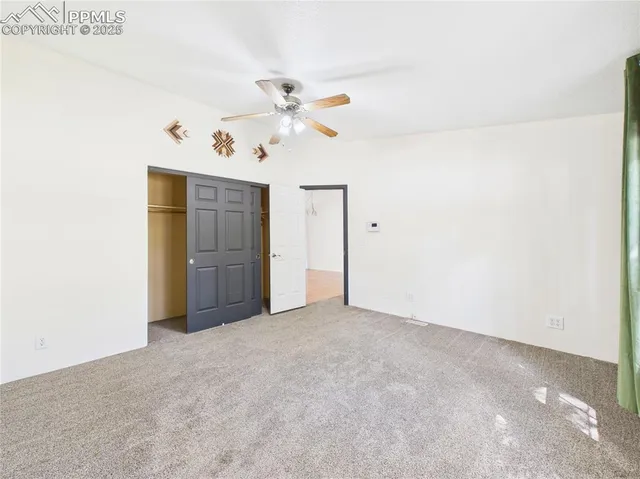 an empty room with windows and closet