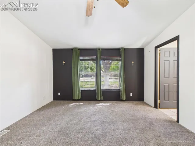 a spacious bathroom with a toilet a sink and mirror