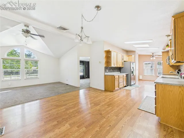 a kitchen with stainless steel appliances granite countertop a refrigerator and a stove