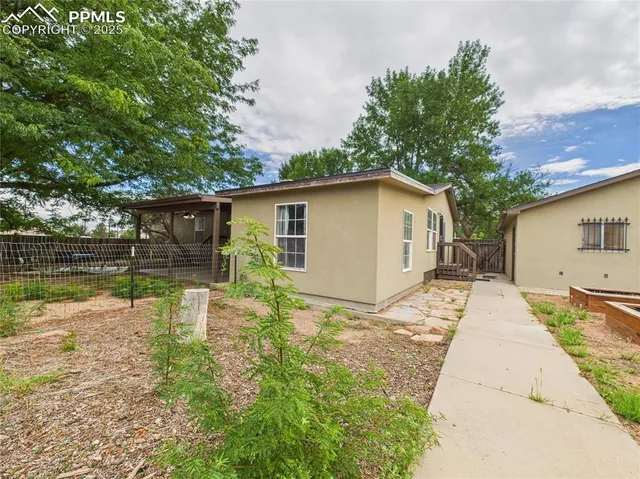 a view of a house with a yard and sitting area