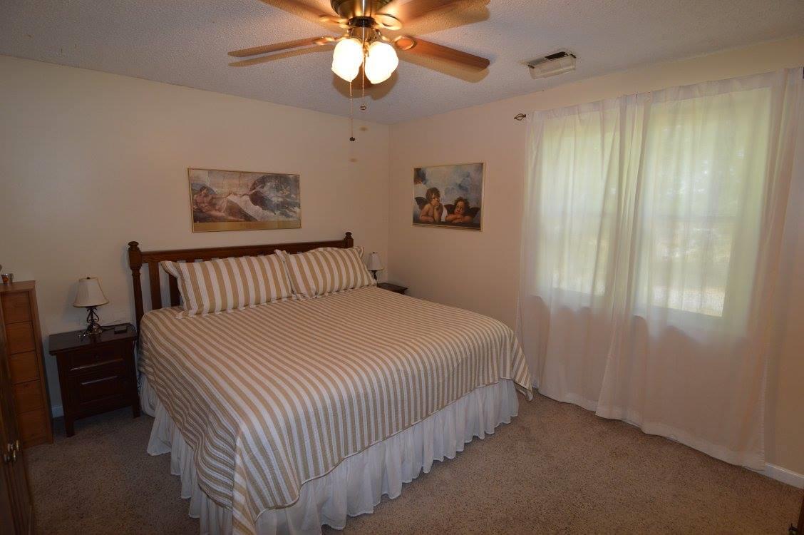 101 Bettis Road Lebanon, TN 37090 - Photo 17 of 20 a bedroom with a bed and a chandelier