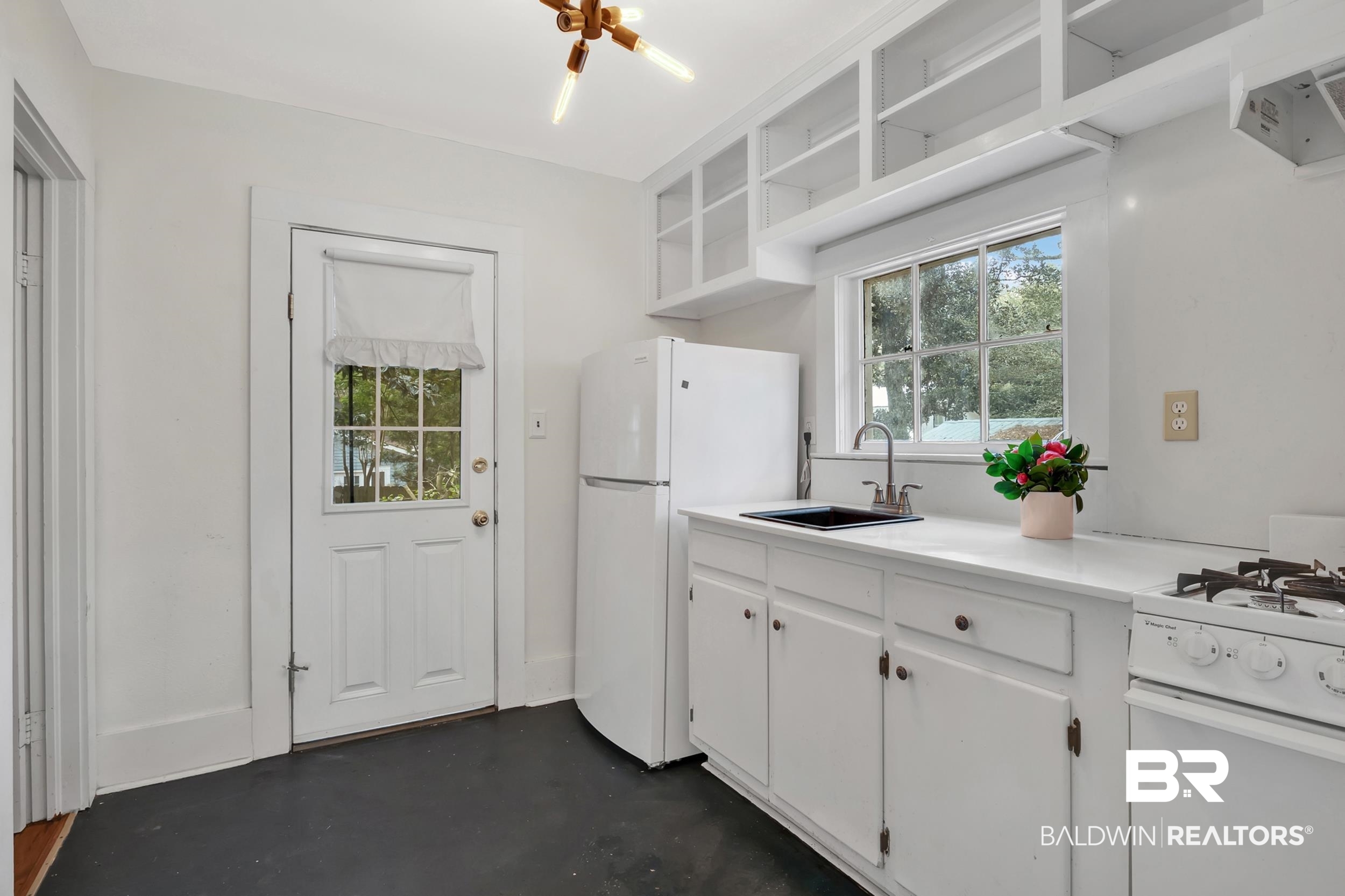 55 Boise Lane Fairhope, AL 36532 - Photo 9 of 24 Kitchen featuring open shelves, white appliances, a sink, and a wealth of natural light