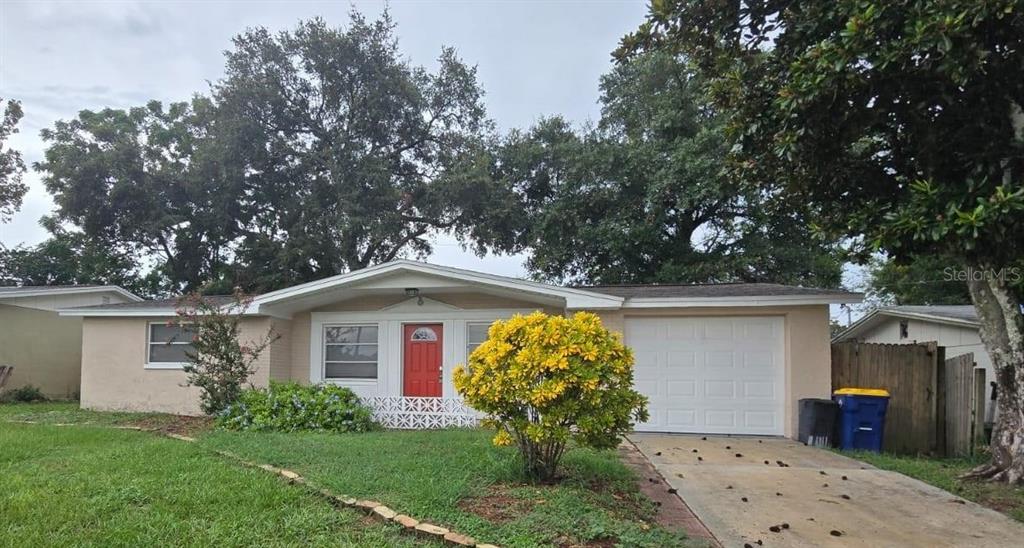 5304 Reef Drive New Port Richey, FL 34652 - Photo 1 of 1 a front view of house with garden