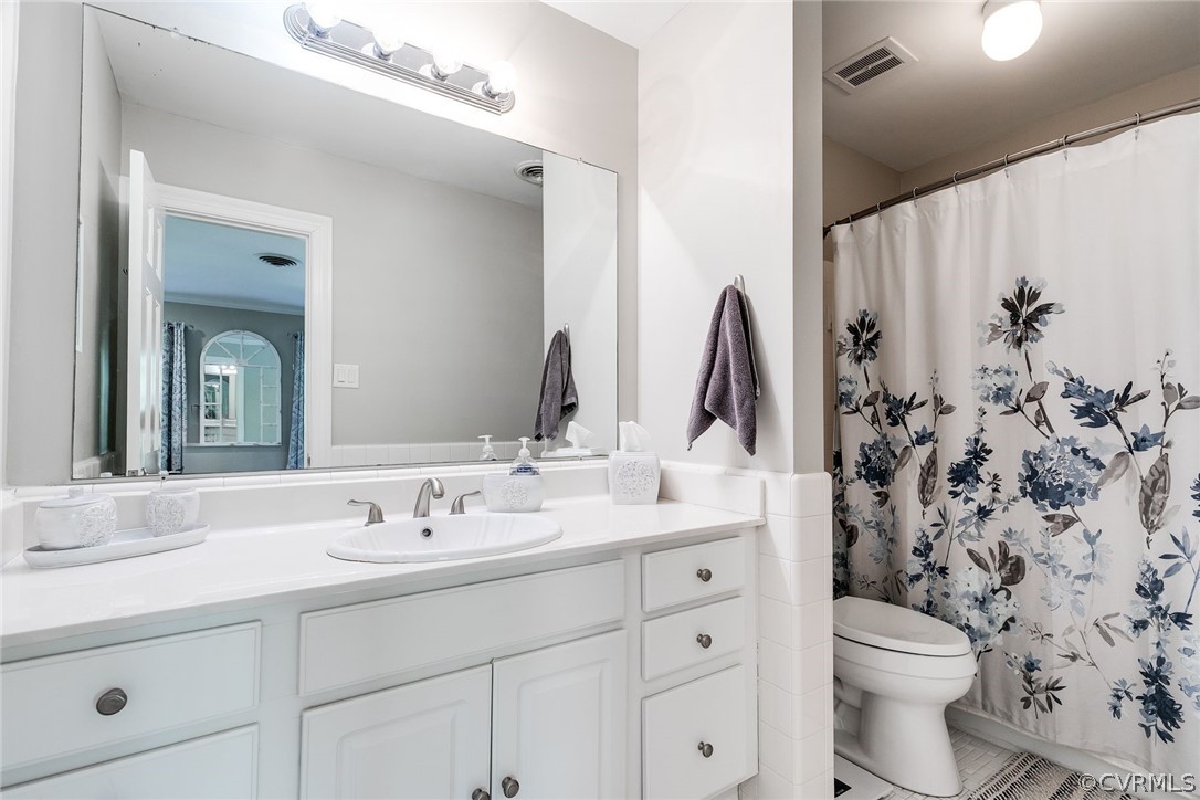 300 North Ridge Road, Unit 3 Richmond, VA 23229 - Photo 15 of 20 a bathroom with a toilet sink and mirror
