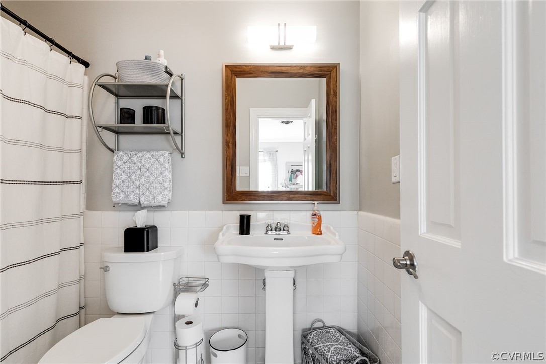 300 North Ridge Road, Unit 3 Richmond, VA 23229 - Photo 17 of 20 a bathroom with a toilet sink and mirror