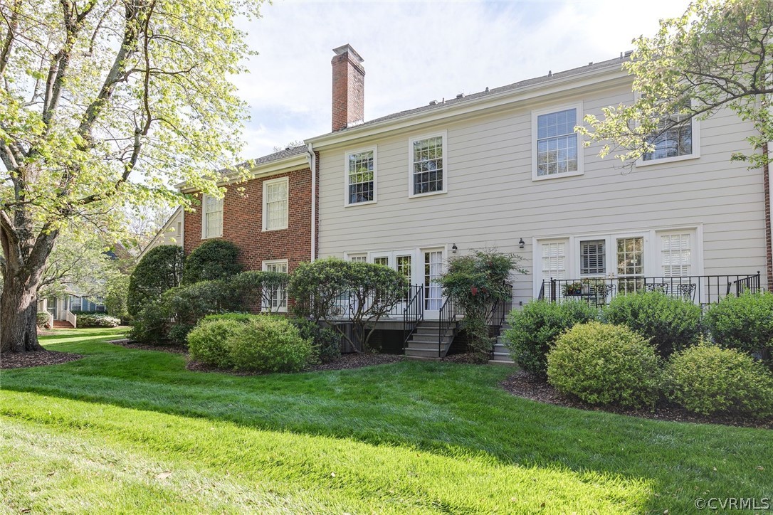 300 North Ridge Road, Unit 3 Richmond, VA 23229 - Photo 19 of 20 a front view of a house with a yard and potted plants