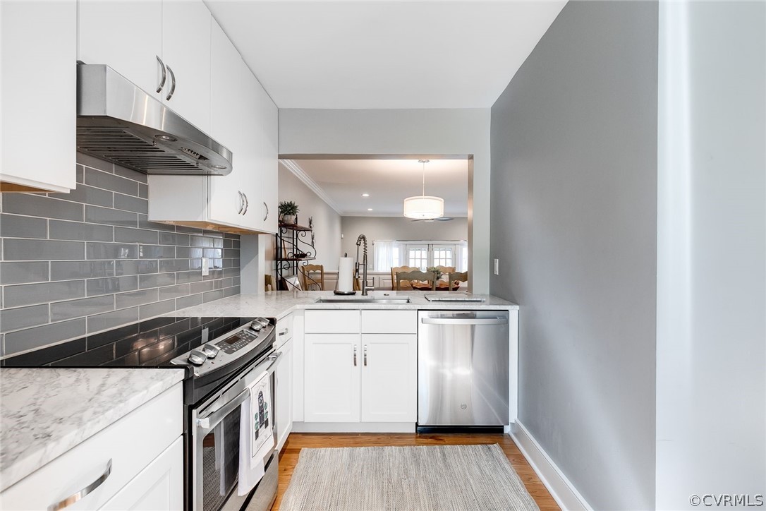 300 North Ridge Road, Unit 3 Richmond, VA 23229 - Photo 5 of 20 a kitchen with stainless steel appliances granite countertop a stove a sink and a refrigerator