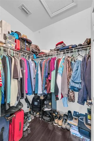 a view of walk in closet with clothes